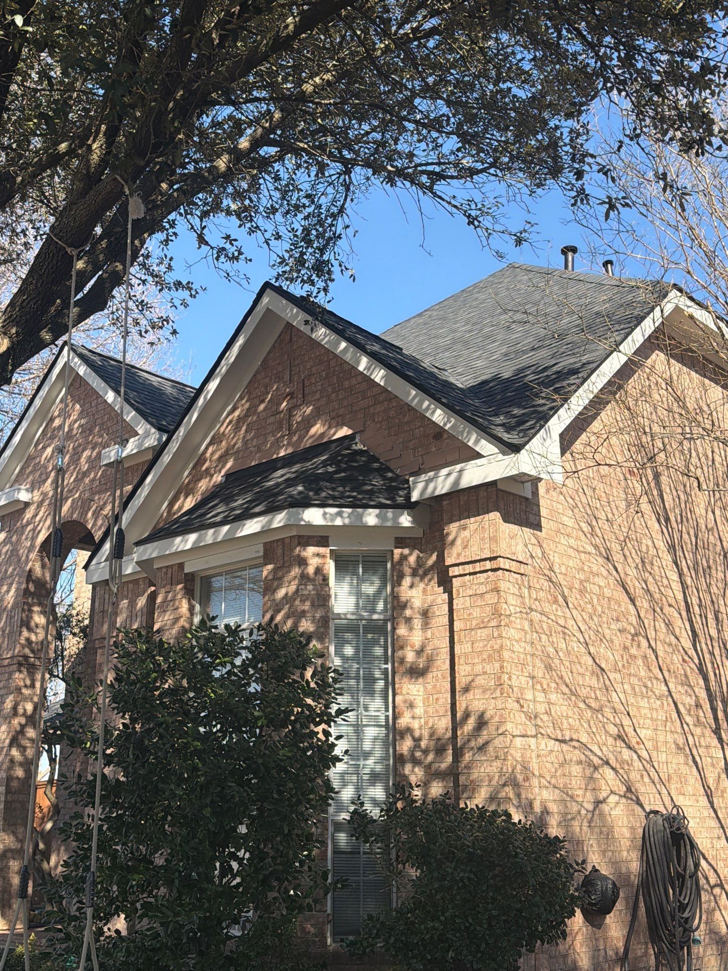 Brick Dallas home with new dark architectural shingle roof