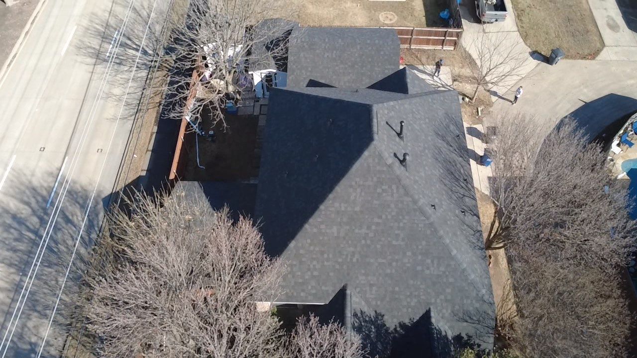Aerial view of newly installed charcoal shingle roof